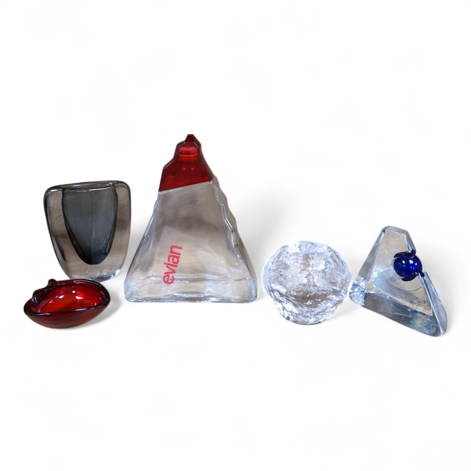 A collection of glassware including a Kosta Boda snowball pot and an Evian advertising water bottle, largest 23cm high